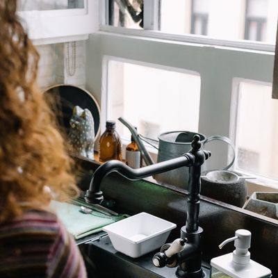 A bottle of water next to a window with soft morning light.